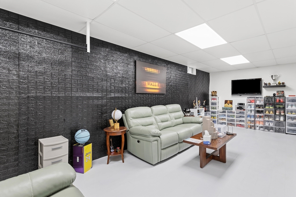 5D Manor Drive, Unit B Hooksett, NH 03106 - Photo 36 of 42 a living room with furniture and a flat screen tv