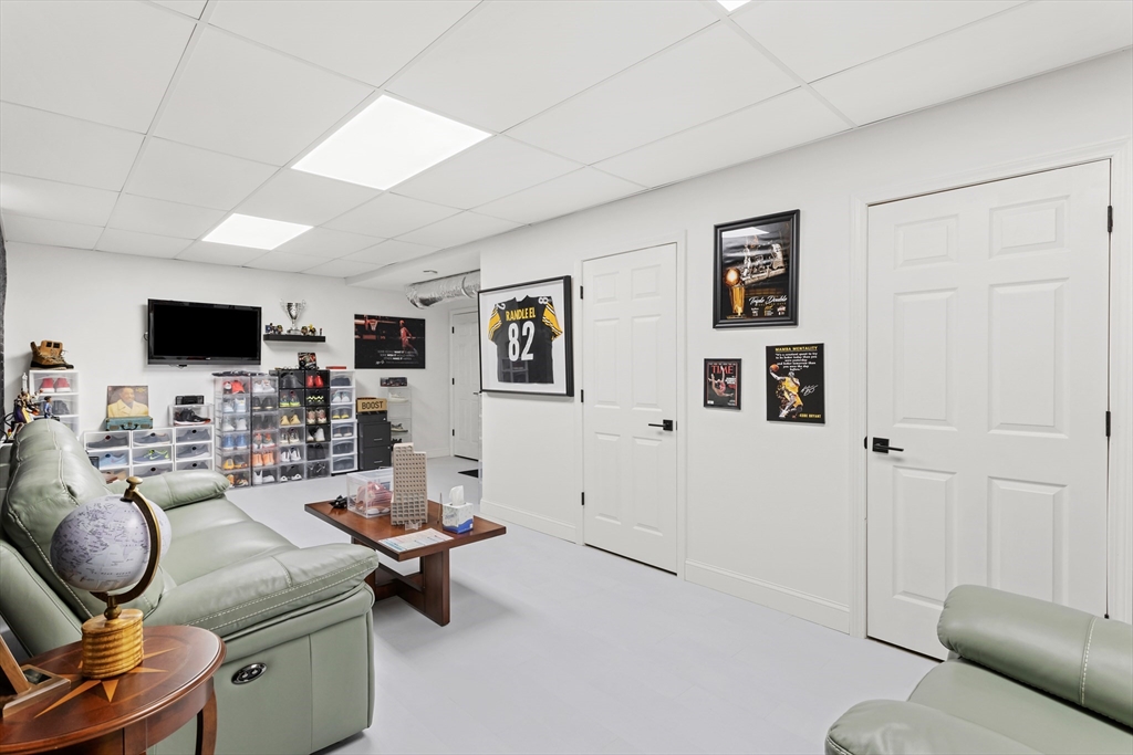 5D Manor Drive, Unit B Hooksett, NH 03106 - Photo 37 of 42 a living room with furniture and a flat screen tv