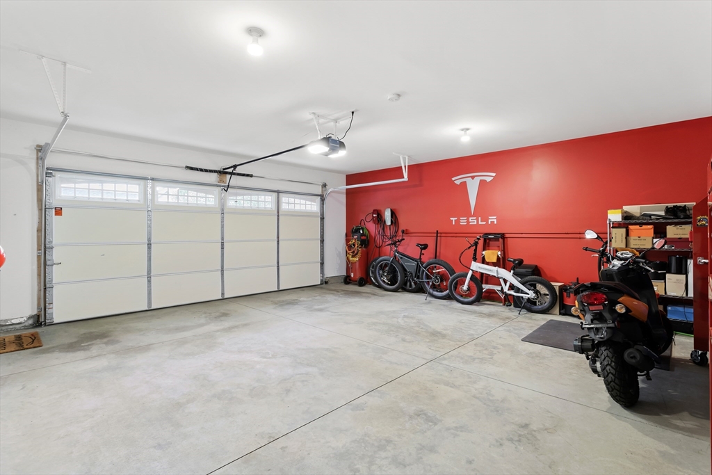 5D Manor Drive, Unit B Hooksett, NH 03106 - Photo 38 of 42 a view of a garage with a table and chairs