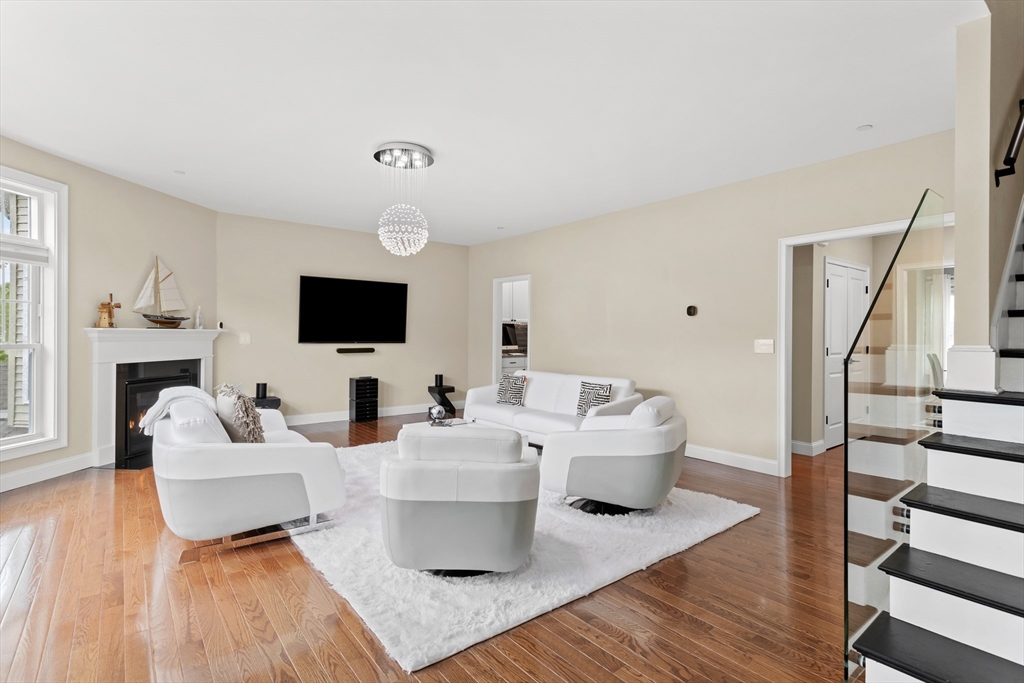 5D Manor Drive, Unit B Hooksett, NH 03106 - Photo 7 of 42 a living room with furniture a flat screen tv and a fireplace