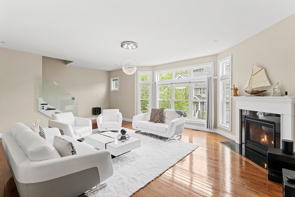5D Manor Drive, Unit B Hooksett, NH 03106 - Photo 10 of 42 a living room with furniture fireplace and a large window