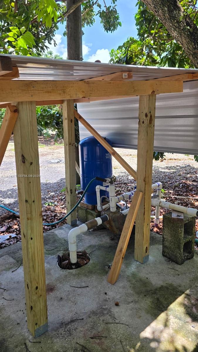 20970 Southwest 296th Street Homestead, FL 33030 - Photo 3 of 14 a view of a porch with furniture and a fire pit