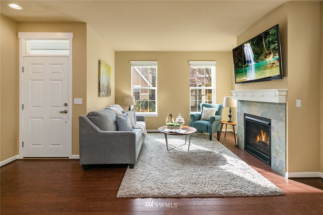 3807 219th Street Southeast Bothell, WA 98021 - Photo 3 of 23 a living room with furniture and a fireplace