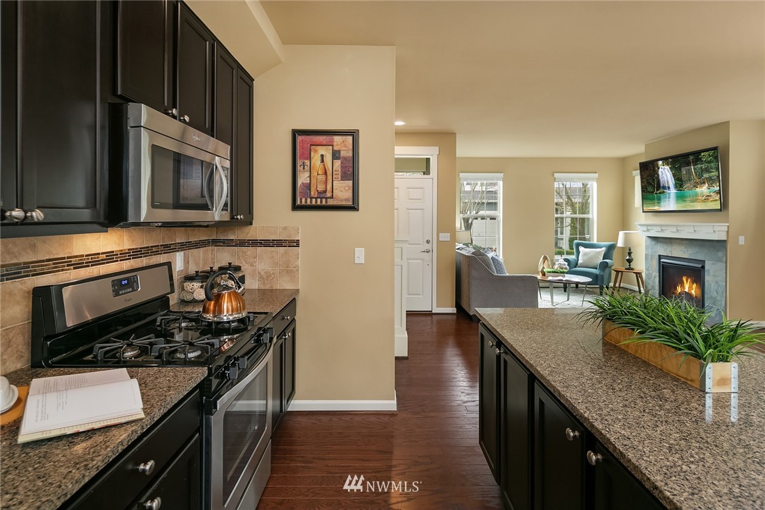 3807 219th Street Southeast Bothell, WA 98021 - Photo 8 of 23 a kitchen with stainless steel appliances granite countertop a stove a sink and a microwave