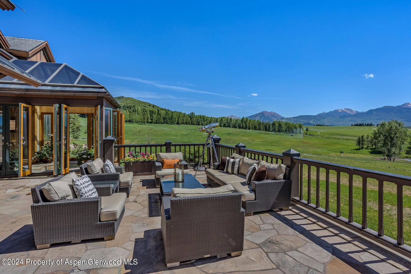 1200 Kessler Drive Aspen, CO 81612 - Photo 14 of 58 a view of a patio with couches chairs potted plants and ocean view