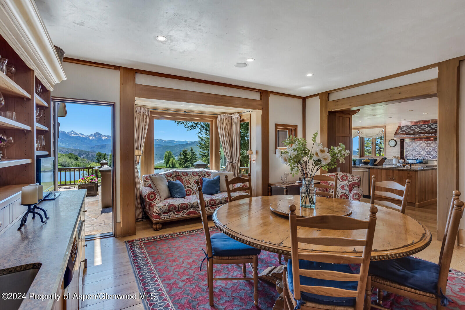 1200 Kessler Drive Aspen, CO 81612 - Photo 17 of 58 a dining room with furniture a rug and a floor to ceiling window