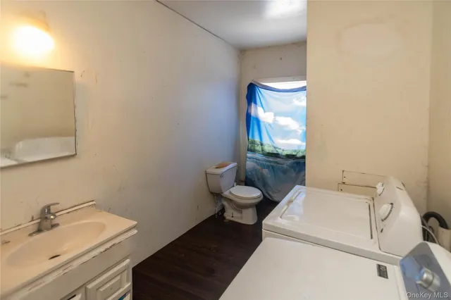 a bathroom with a toilet a sink and mirror