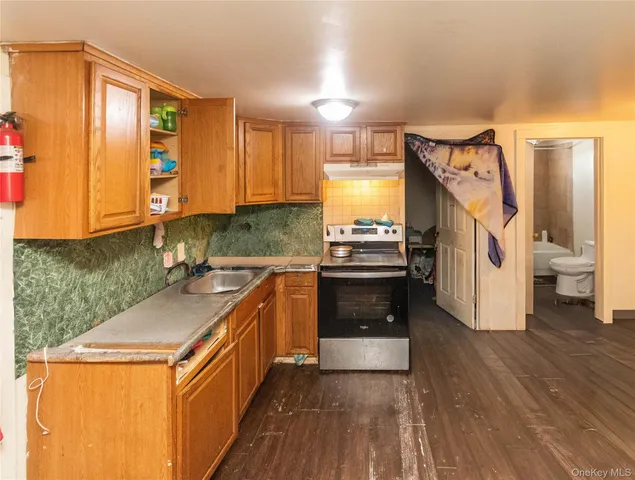 a kitchen with stainless steel appliances granite countertop a sink and a stove
