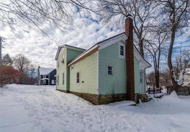 a view of a house with a snow in the yard