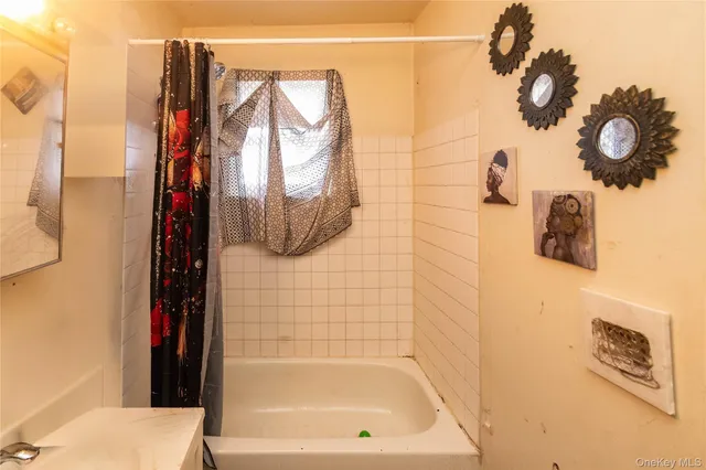 a bathroom with a shower and a sink