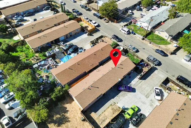 an aerial view of a house with a yard