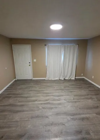 a view of an empty room and wooden floor