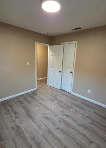 a view of an empty room and wooden floor