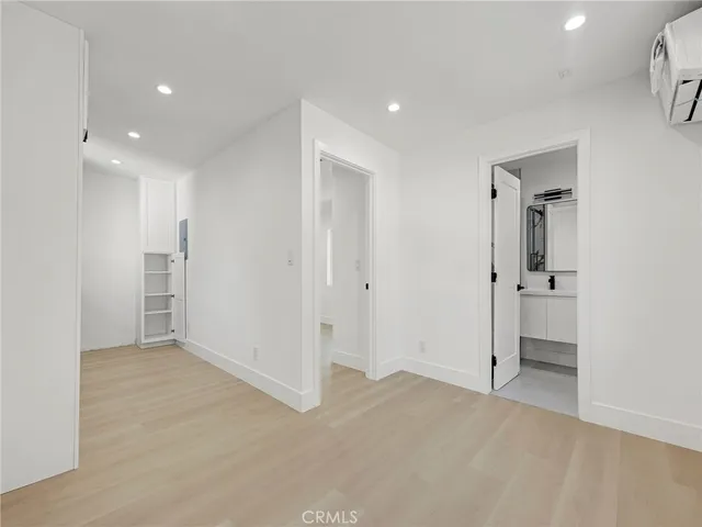 an empty room with closet and a bathroom