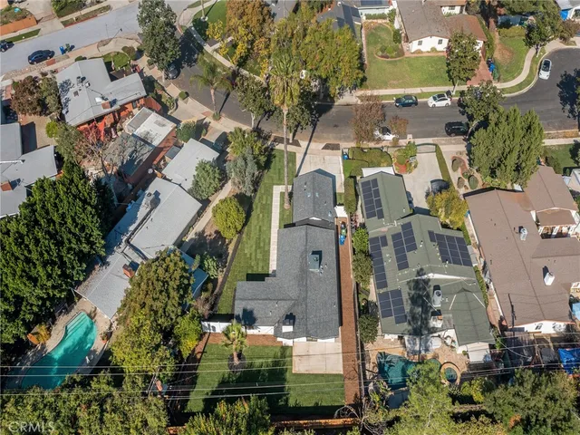 an aerial view of residential houses with outdoor space