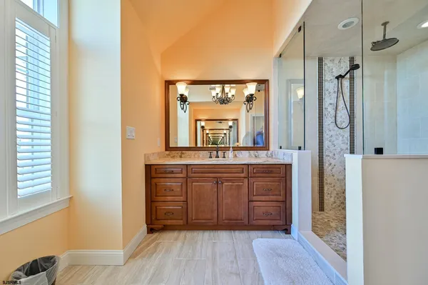 a bathroom with a sink toilet a mirror and shower