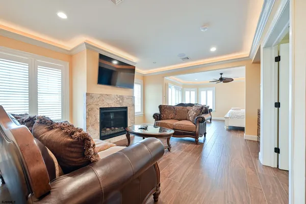 a view of a hallway with wooden floor and a potted plant