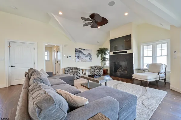 a living room with furniture fireplace and a flat screen tv