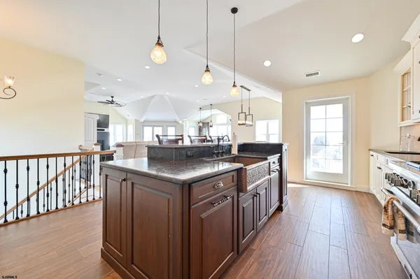 a kitchen with stainless steel appliances white cabinets and wooden floors