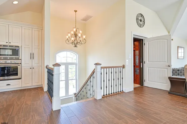a kitchen with stainless steel appliances granite countertop a stove a sink a oven a dining table and chairs