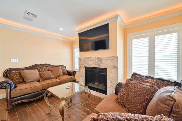 a kitchen with stainless steel appliances kitchen island granite countertop a table chairs and white cabinets