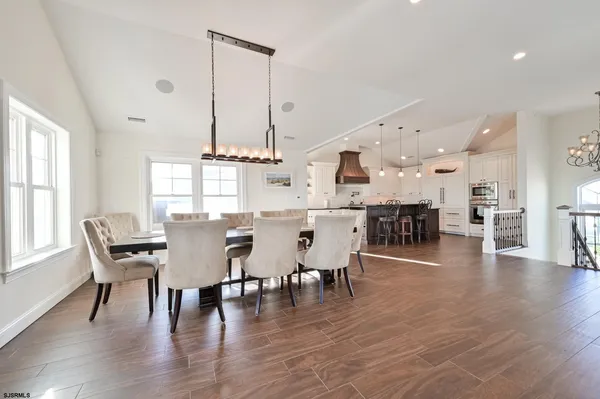 a dining room with furniture window and wooden floor