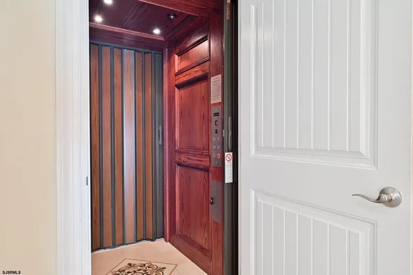 a view of a livingroom with wooden floor and a large window