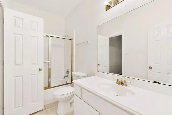 front view of a brick house with a yard