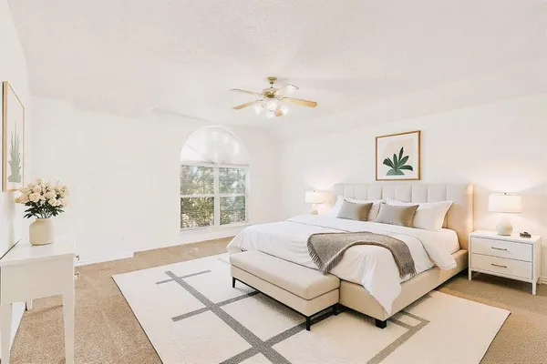 a living room with a bed furniture and a chandelier