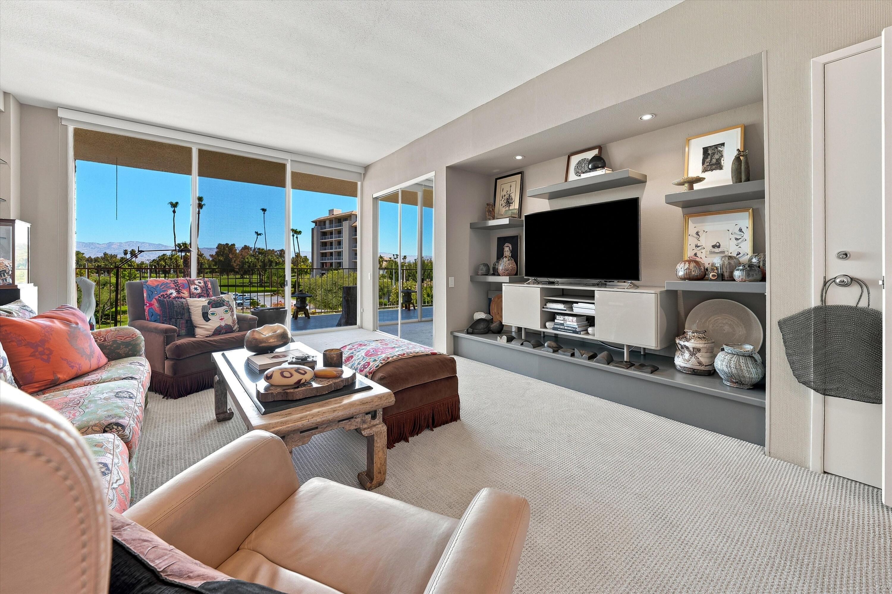 899 Island Drive, Unit 304 Rancho Mirage, CA 92270 - Photo 14 of 30 a living room with furniture and a flat screen tv