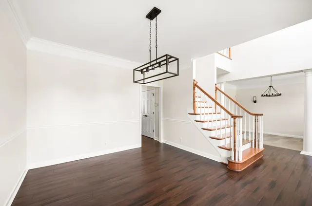 a view of a room with a window and chandelier