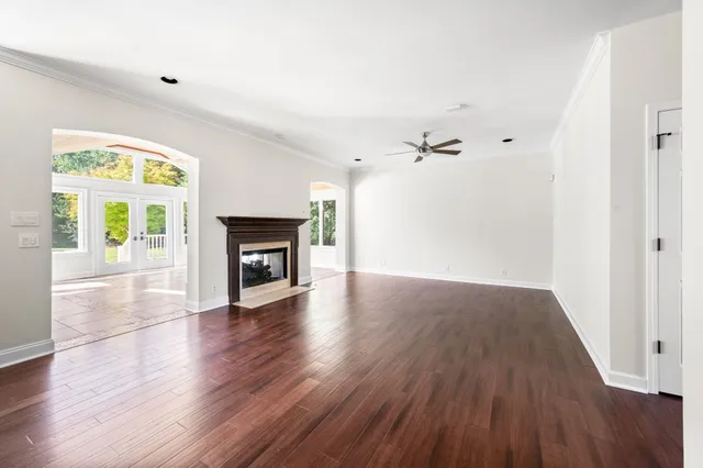 a kitchen with stainless steel appliances granite countertop a refrigerator a sink and white cabinets