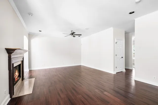 a kitchen with a stove a refrigerator a sink dishwasher with a dining table and chairs with wooden floor