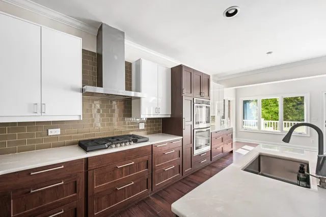 an empty room with windows and chandelier