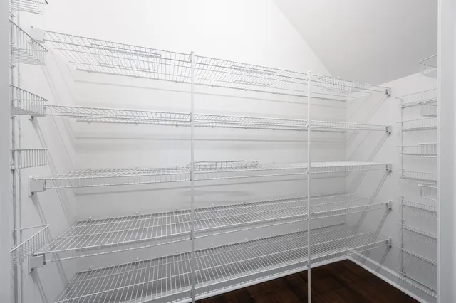 a bathroom with a granite countertop sink a mirror and a shower