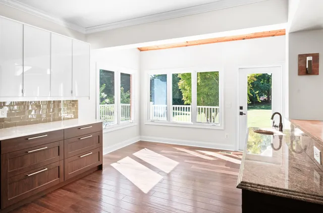 a view of room with a window and a ceiling fan