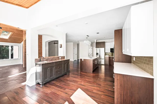a bathroom with a sink a mirror and a shower