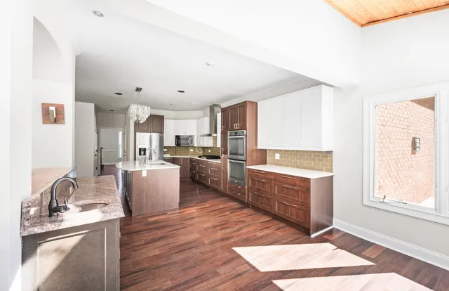 an empty room with a window and a ceiling fan