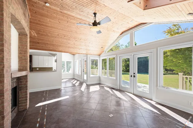a view of a livingroom with a ceiling fan and window