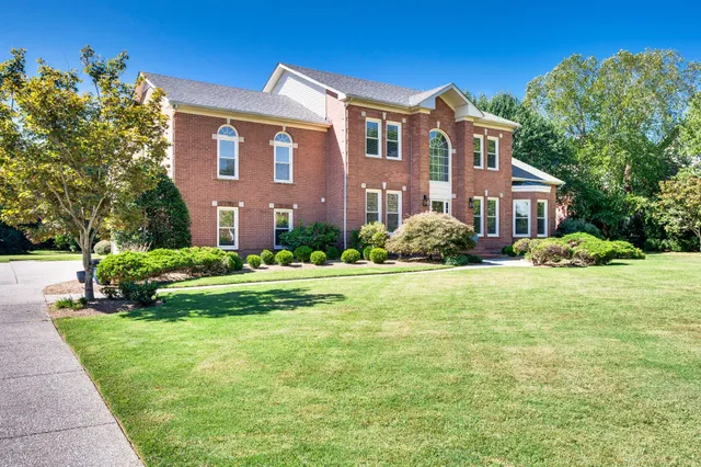 a view of a brick house with potted plants