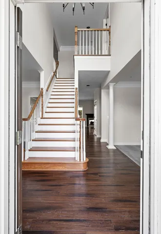 a view of entryway and hall with wooden floor