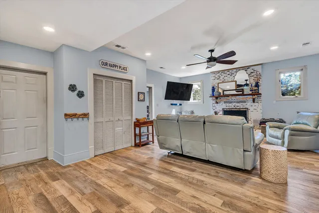 a living room with furniture a fireplace and a flat screen tv