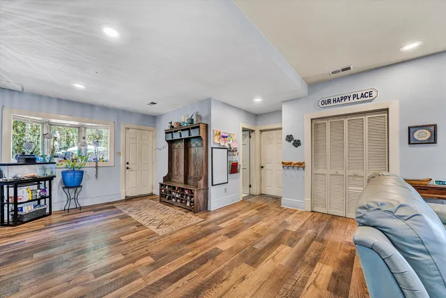 a large kitchen with stainless steel appliances kitchen island granite countertop a large counter top and wooden floors