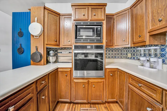 a view of a dining room with furniture a chandelier and wooden floor