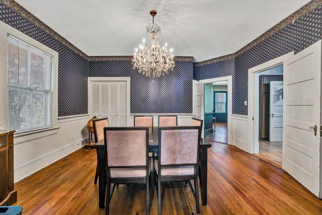 a spacious bedroom with a bed a fireplace and a television