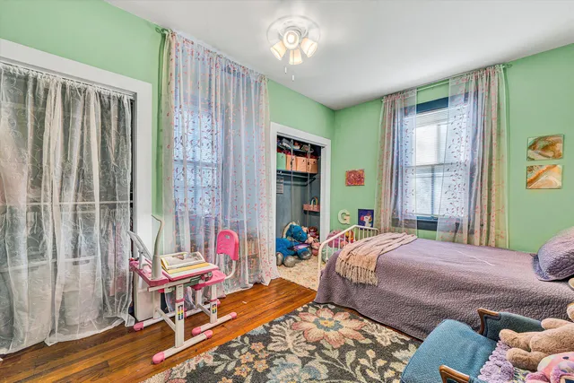 a view of a house with backyard and a tree