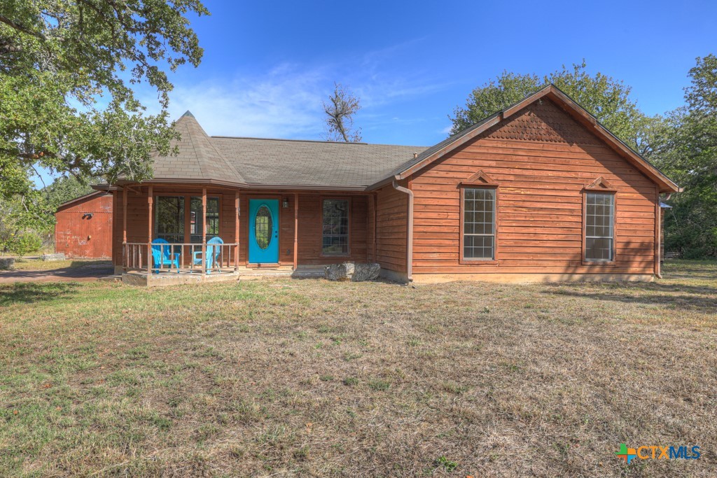 a view of a house with a backyard