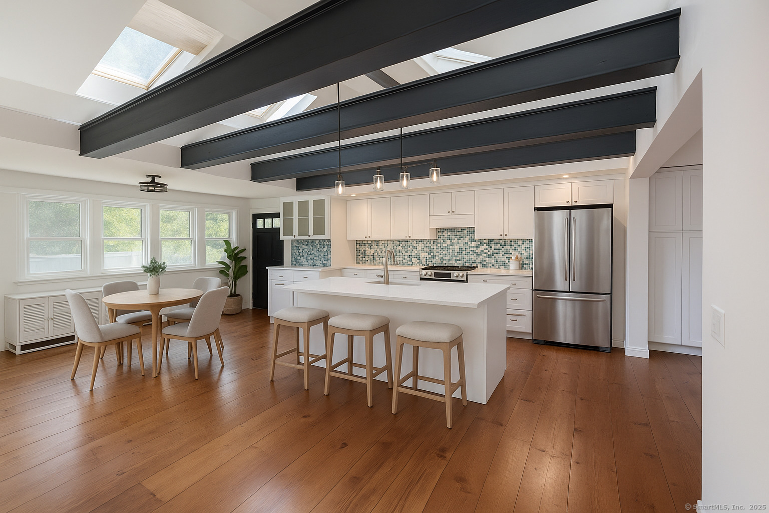11 Pond Circle Road Westbrook, CT 06498 - Photo 2 of 22 a kitchen with stainless steel appliances a dining table chairs and wooden floor