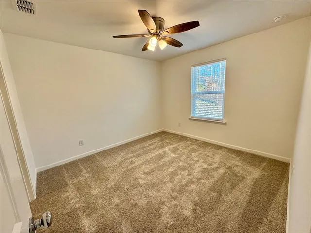 a bathroom with a glass shower door and a sink