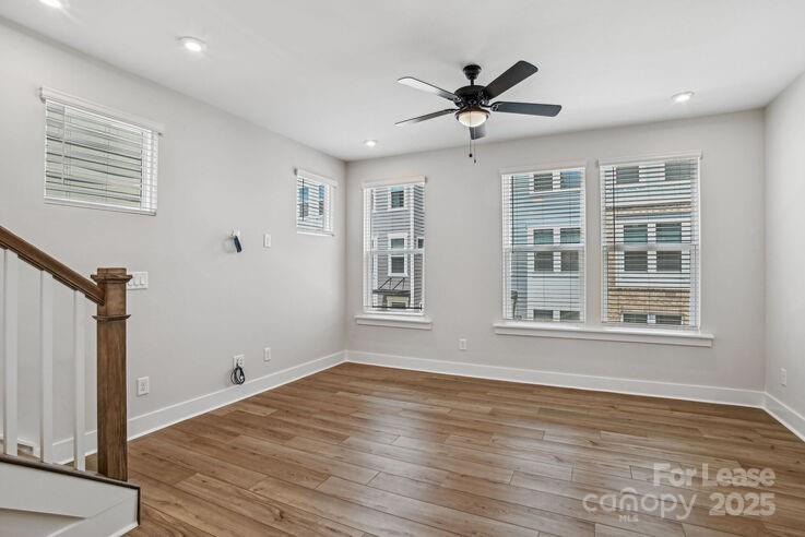 4375 Raleigh Street, Unit B1 Charlotte, NC 28213 - Photo 12 of 19 a view of empty room with wooden floor and fan